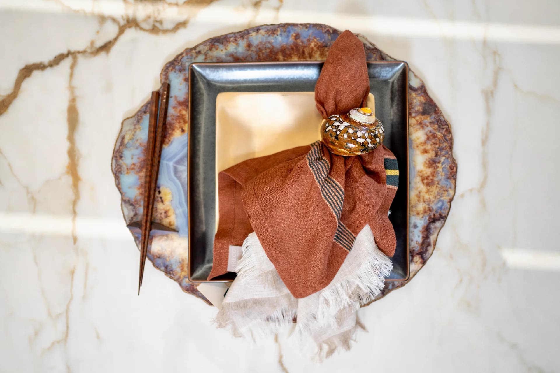 a luxury tablescape with neutral coloured tableware