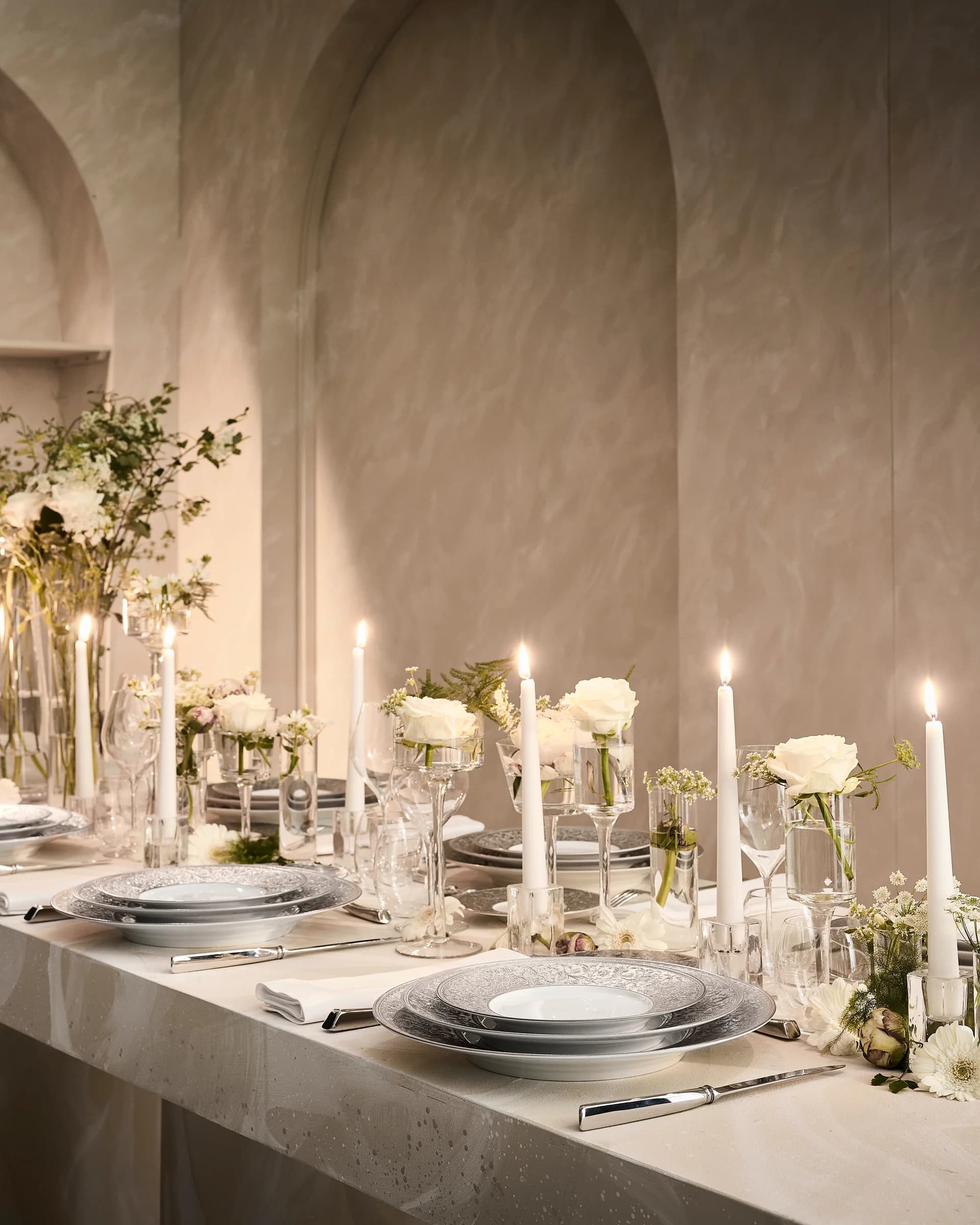 An elegant table setting featuring luxury plates, glassware, and cutlery.